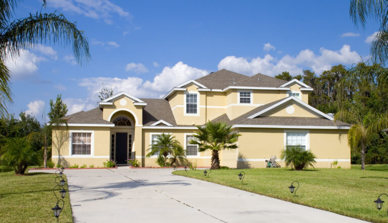 pressure washing miami floridahouse-with-large-front-door-blue-sky-with-tree-background-scaled.jpg